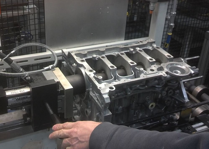 Pneumatic expanding pin separates engine block after machining